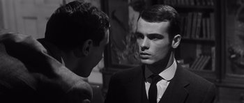 Movie still from “Compulsion” (1959), directed by Richard Fleischer – Two young men in suits talking to each other; Close Up shot, Over the shoulder angle