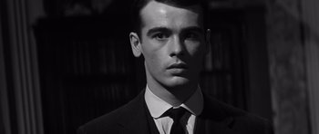 Movie still from “Compulsion” (1959), directed by Richard Fleischer – Black and white photograph of a man in a suit and tie; Close Up shot, Low angle