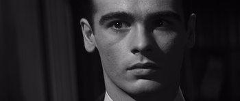 Movie still from “Compulsion” (1959), directed by Richard Fleischer – Black and white photograph of a young man's face; Close Up shot, Low angle
