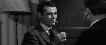 Movie still from “Compulsion” (1959), directed by Richard Fleischer – A black and white photo of a man smoking a cigarette; Close Up shot, Low angle
