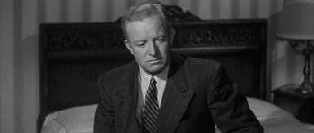 Movie still from “Compulsion” (1959), directed by Richard Fleischer – An older man in a suit and tie; Close Up shot, Low angle