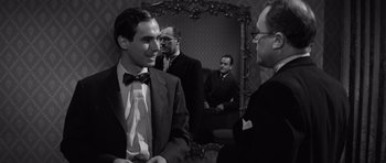 Movie still from “Compulsion” (1959), directed by Richard Fleischer – A group of men standing next to each other in front of a mirror; Medium shot, Over the shoulder angle