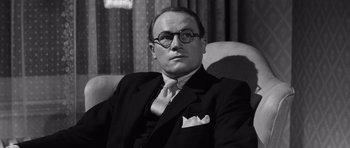 Movie still from “Compulsion” (1959), directed by Richard Fleischer – An older man wearing a suit and tie; Close Up shot, Low angle