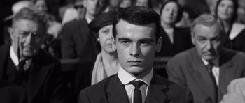 Movie still from “Compulsion” (1959), directed by Richard Fleischer – Black and white photograph of a man in a suit and tie; Close Up shot, High angle