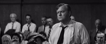 Movie still from “Compulsion” (1959), directed by Richard Fleischer – Black and white photograph of a man in a crowd; Medium shot, Low angle