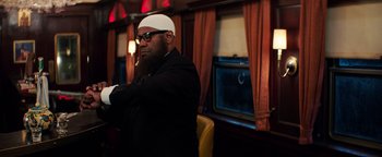 Movie still from “The Equalizer 2” (2018), directed by Antoine Fuqua – A man with a beard wearing a white hat; Medium shot, Low angle