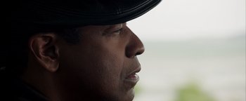 Movie still from “The Equalizer 2” (2018), directed by Antoine Fuqua – A person wearing a black hat; Close Up shot, Over the shoulder angle