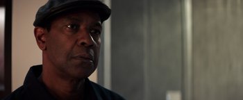 Movie still from “The Equalizer 2” (2018), directed by Antoine Fuqua – A person wearing a hat; Close Up shot, Over the shoulder angle