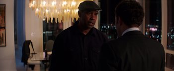 Movie still from “The Equalizer 2” (2018), directed by Antoine Fuqua – A man wearing a hat talking to a man; Medium shot, Over the shoulder angle