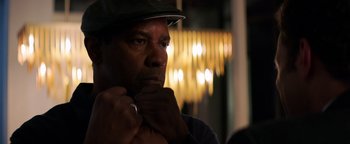 Movie still from “The Equalizer 2” (2018), directed by Antoine Fuqua – A man with a hat is looking at the camera; Close Up shot, Over the shoulder angle