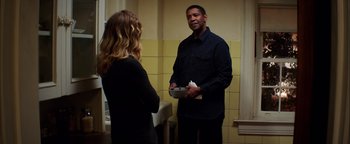 Movie still from “The Equalizer 2” (2018), directed by Antoine Fuqua – A man and a woman are standing in front of a mirror; Medium shot, Over the shoulder angle