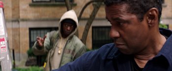 Movie still from “The Equalizer 2” (2018), directed by Antoine Fuqua – Two men standing next to each other on a street; Close Up shot, Over the shoulder angle