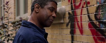 Movie still from “The Equalizer 2” (2018), directed by Antoine Fuqua – A man standing in front of a brick wall; Close Up shot, Low angle