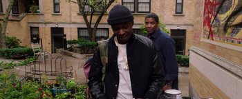 Movie still from “The Equalizer 2” (2018), directed by Antoine Fuqua – A man wearing a hat and a leather jacket; Medium shot, Over the shoulder angle