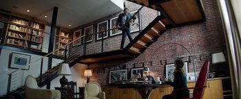 Movie still from “The Equalizer 2” (2018), directed by Antoine Fuqua – A man standing on the bottom of a stair case; Wide shot, Low angle