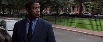 Movie still from “The Equalizer 2” (2018), directed by Antoine Fuqua – A person wearing a suit and tie; Close Up shot, Over the shoulder angle