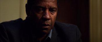 Movie still from “The Equalizer 2” (2018), directed by Antoine Fuqua – A person wearing a suit and tie; Close Up shot, Low angle