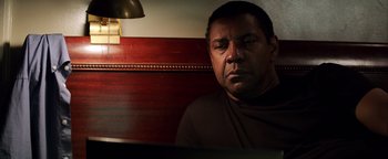 Movie still from “The Equalizer 2” (2018), directed by Antoine Fuqua – A person sitting at a table; Close Up shot, High angle