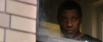 Movie still from “The Equalizer 2” (2018), directed by Antoine Fuqua – A person looking out of a window; Close Up shot, Over the shoulder angle
