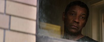 Movie still from “The Equalizer 2” (2018), directed by Antoine Fuqua – A person looking out of a window; Close Up shot, Low angle