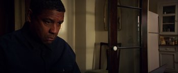 Movie still from “The Equalizer 2” (2018), directed by Antoine Fuqua – A person sitting in a room; Close Up shot, Low angle