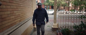 Movie still from “The Equalizer 2” (2018), directed by Antoine Fuqua – A man walking down the street wearing a helmet; Medium shot, Low angle