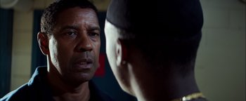 Movie still from “The Equalizer 2” (2018), directed by Antoine Fuqua – Two men are facing each other in a dark room; Close Up shot, Over the shoulder angle