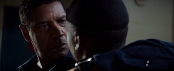 Movie still from “The Equalizer 2” (2018), directed by Antoine Fuqua – A man and a woman face to face in a dark room; Close Up shot, Over the shoulder angle