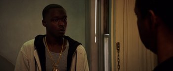 Movie still from “The Equalizer 2” (2018), directed by Antoine Fuqua – A man standing next to a door in a room; Close Up shot, Over the shoulder angle