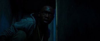 Movie still from “The Equalizer 2” (2018), directed by Antoine Fuqua – A man with a beard is standing in a dark room; Close Up shot, Low angle