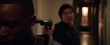 Movie still from “The Equalizer 2” (2018), directed by Antoine Fuqua – A man holding a gun in front of another man; Close Up shot, Over the shoulder angle