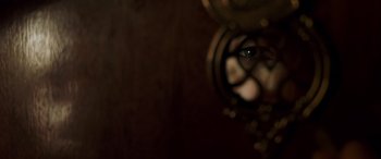 Movie still from “Confessions of a Dangerous Mind” (2002), directed by George Clooney – A person's eye is reflected in a mirror; Extreme Close Up shot, Low angle