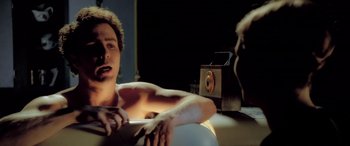 Movie still from “Confessions of a Dangerous Mind” (2002), directed by George Clooney – A man sitting in a bathtub next to an old radio; Close Up shot, Over the shoulder angle