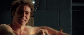 Movie still from “Confessions of a Dangerous Mind” (2002), directed by George Clooney – A young man is smiling for the camera; Close Up shot, Over the shoulder angle