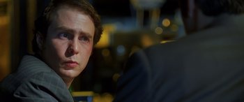 Movie still from “Confessions of a Dangerous Mind” (2002), directed by George Clooney – A young man sitting in a chair looking into the camera; Close Up shot, Over the shoulder angle