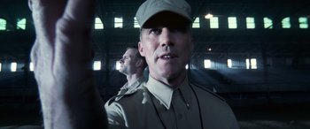 Movie still from “Confessions of a Dangerous Mind” (2002), directed by George Clooney – A man in a uniform and a man in a hat; Close Up shot, Low angle