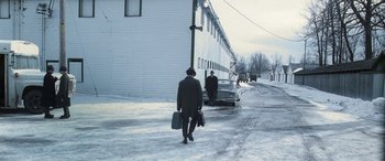 Movie still from “Confessions of a Dangerous Mind” (2002), directed by George Clooney – A man walking down the street with his luggage; Extreme Wide shot, High angle