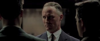 Movie still from “Confessions of a Dangerous Mind” (2002), directed by George Clooney – A person wearing a suit and tie; Close Up shot, Low angle