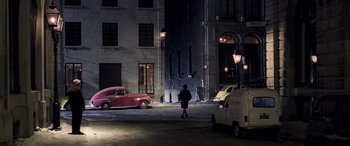 Movie still from “Confessions of a Dangerous Mind” (2002), directed by George Clooney – A man walking down the street at night; Extreme Wide shot, High angle