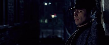 Movie still from “Confessions of a Dangerous Mind” (2002), directed by George Clooney – A man wearing a hat standing in the dark; Close Up shot, Over the shoulder angle