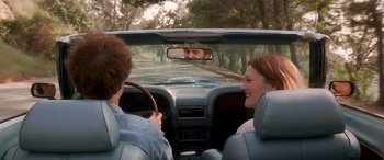 Movie still from “Confessions of a Dangerous Mind” (2002), directed by George Clooney – A man and woman in the back seat of a car; Medium shot, Over the shoulder angle