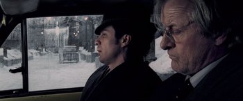 Movie still from “Confessions of a Dangerous Mind” (2002), directed by George Clooney – A man and a woman are looking out a window; Close Up shot, Low angle