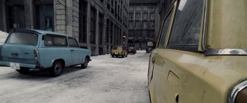 Movie still from “Confessions of a Dangerous Mind” (2002), directed by George Clooney – Cars are parked on the side of the road in the snow; Extreme Wide shot, High angle