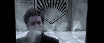 Movie still from “Confessions of a Dangerous Mind” (2002), directed by George Clooney – A man smoking a cigarette in front of an electric fan; Close Up shot, Low angle