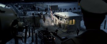 Movie still from “Confessions of a Dangerous Mind” (2002), directed by George Clooney – A group of people standing next to each other near a building; Extreme Wide shot, High angle