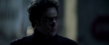 Movie still from “Confessions of a Dangerous Mind” (2002), directed by George Clooney – A person with a bandage on his face; Close Up shot, Low angle