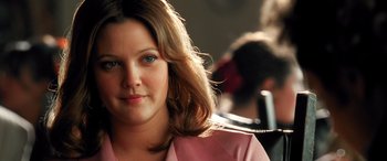 Movie still from “Confessions of a Dangerous Mind” (2002), directed by George Clooney – A person wearing a pink shirt; Close Up shot, Over the shoulder angle