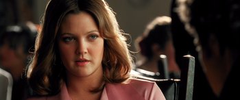 Movie still from “Confessions of a Dangerous Mind” (2002), directed by George Clooney – A person wearing a pink jacket; Close Up shot, Over the shoulder angle