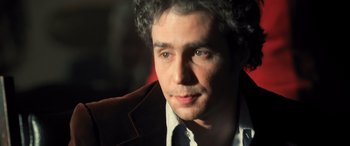 Movie still from “Confessions of a Dangerous Mind” (2002), directed by George Clooney – A person wearing a suit and tie; Close Up shot, Over the shoulder angle