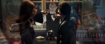 Movie still from “Confessions of a Dangerous Mind” (2002), directed by George Clooney – A man in a black vest and a black bow tie; Medium shot, Over the shoulder angle